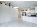 Modern kitchen with stainless steel appliances and a breakfast bar at 3123 W Rio Vista Ave, Tampa, FL 33614