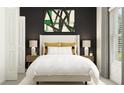 Cozy bedroom with a beige upholstered bed and dark accent wall at 35233 Gravelly Dr, Zephyrhills, FL 33541