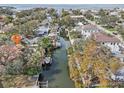 Stunning aerial view of a waterfront neighborhood with canals and private boat docks on a sunny day at 4829 W San Miguel St, Tampa, FL 33629