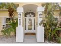 Front entry with arched entryway, double columns, and glass door at 538 25Th Se Ave, St Petersburg, FL 33705