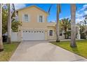 Two-car garage with white doors and light yellow exterior at 538 25Th Se Ave, St Petersburg, FL 33705