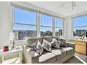 Bright living room featuring large windows and comfortable seating with water views at 5575 Gulf Blvd # 425, St Pete Beach, FL 33706