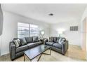 Cozy living room with two gray sofas and a coffee table at 6105 Antrim St, New Port Richey, FL 34653