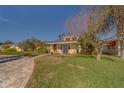 House exterior showcasing landscaping and a paved driveway at 783 Placido Ne Way, St Petersburg, FL 33704