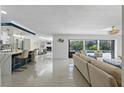 Open floor plan living room with a view of the pool and kitchen at 900 31St Ne Ave, St Petersburg, FL 33704