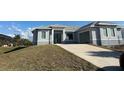 Gray house with landscaping and driveway at 10658 Rainsville St, Port Charlotte, FL 33981