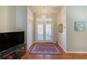 Bright entryway with hardwood floors and double glass doors at 11440 Baronwood Ct, Hudson, FL 34667