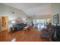 Spacious living room featuring hardwood floors and lots of natural light at 11440 Baronwood Ct, Hudson, FL 34667