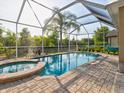 Enclosed pool and spa with a covered patio at 12211 Oak Ramble Dr, Spring Hill, FL 34610