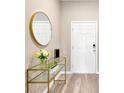 Bright entryway with a glass-top console table and a round gold mirror at 12931 Twin Bridges Dr, Riverview, FL 33579