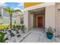 Home's inviting front entrance with a walkway and landscaping at 12931 Twin Bridges Dr, Riverview, FL 33579