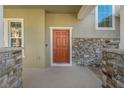 Attractive orange front door with stone accents at 1317 Lorea Ln, Brandon, FL 33511