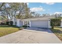 House exterior showcasing a gray garage door and driveway at 13214 Moran Dr, Tampa, FL 33618