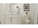 Clean bathroom with white vanity, toilet, and shower at 15233 Rainbow Quartz St, Wimauma, FL 33598