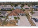 Aerial view of a single-Gathering home in a residential neighborhood at 2457 E Del Webb Blvd, Sun City Center, FL 33573
