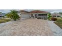 Charming Florida home with paver driveway and landscaping at 2457 E Del Webb Blvd, Sun City Center, FL 33573