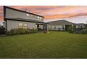 Spacious backyard with green grass, a screened patio, and a fence at 4062 Cadence Loop, Land O Lakes, FL 34638