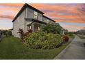 Two-story house with a white facade, landscaping, and a walkway at 4062 Cadence Loop, Land O Lakes, FL 34638