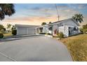 White single story home with two car garage and mature landscaping at 713 Gran Kaymen Way, Apollo Beach, FL 33572