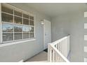 Private balcony with white railings and window at 7713 Hillside Ct # 201, Hudson, FL 34667