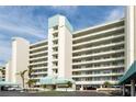 Modern condo building featuring multiple balconies, covered parking and manicured landscaping at 7963 Sailboat Key S Blvd # 408, South Pasadena, FL 33707
