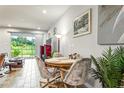 Small dining area with a round table and chairs, near a sliding glass door at 8321 Wildflower Glen Ave, Odessa, FL 33556