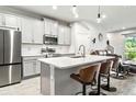 Modern kitchen with gray cabinets, stainless steel appliances, and quartz countertops at 8321 Wildflower Glen Ave, Odessa, FL 33556