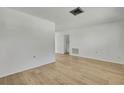 Bright living room with light wood laminate flooring at 9608 Richwood Ln, Port Richey, FL 34668