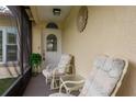 Cozy screened porch with two chairs and a small table at 102 Stafford Dr, Palm Harbor, FL 34684