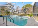 Inviting screened-in pool, perfect for relaxation at 1066 Larkin Rd, Spring Hill, FL 34608