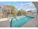 Screened-in pool with a spacious deck and backyard views at 1066 Larkin Rd, Spring Hill, FL 34608