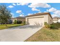 Attached single-car garage with a wide driveway at 12403 Streambed Dr, Riverview, FL 33579