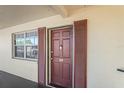 Condo front door entrance with brown door and shutters at 1320 Moreland Dr # 20, Clearwater, FL 33764