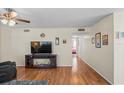 Living room with hardwood floors, TV stand, and access to bedroom at 1320 Moreland Dr # 20, Clearwater, FL 33764