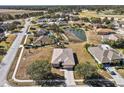 Aerial view showcasing a house in a residential community near a golf course at 2309 Cross Tee Ct, Brooksville, FL 34604