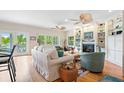 Bright and airy living room with hardwood floors, fireplace and view at 2503 Pass A Grille Way, St Pete Beach, FL 33706