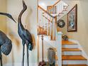 Elegant white staircase with wooden steps and ornate accents at 2503 Pass A Grille Way, St Pete Beach, FL 33706