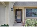 Front door entry with a screen door and a hanging planter at 2579 Bay Berry Dr # 42D, Clearwater, FL 33763