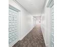 Clean condo hallway with light-colored walls and carpet at 2700 Bayshore Blvd # 1305, Dunedin, FL 34698