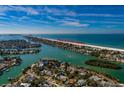 Stunning aerial view of a waterfront neighborhood and Pass-a-Grille Beach in the distance at 3110 W De Bazan Ave, St Pete Beach, FL 33706