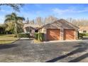 Tan villa with a two-car garage and neatly trimmed hedges at 3185 Charter Club Dr # A, Tarpon Springs, FL 34688