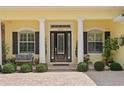 Inviting entryway with black front door, white columns, and lush greenery at 4023 W Horatio St, Tampa, FL 33609