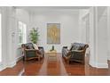 Elegant sitting area with two leather sofas, hardwood floors, and large artwork at 4023 W Horatio St, Tampa, FL 33609