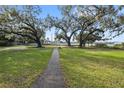 Landscaped yard with a pathway leading to the waterfront at 405 Chastain Rd, Seffner, FL 33584