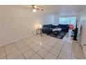 Living room with tiled floors, two sofas, and a coffee table at 4242 Redcliff Pl # C, New Port Richey, FL 34652