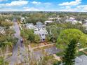 House nestled amongst lush greenery, aerial view showcasing neighborhood at 505 15Th Ne Ave, St Petersburg, FL 33704