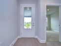 Bright and airy entryway with white door and view to the backyard at 6112 Plover Meadow St, Lithia, FL 33547