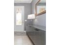 Modern entryway with gray console table and mirror at 6206 Windship Ct, Tampa, FL 33647