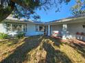 House with covered porch and well-manicured lawn at 7711 Innis Ct, St Petersburg, FL 33709