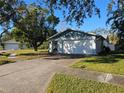 Ranch-style home with attached garage and spacious yard at 7711 Innis Ct, St Petersburg, FL 33709